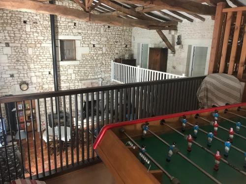 a balcony with a pool table in a room at Chambres d'Hôtes - Les Bujours in Saint-Georges-des-Côteaux