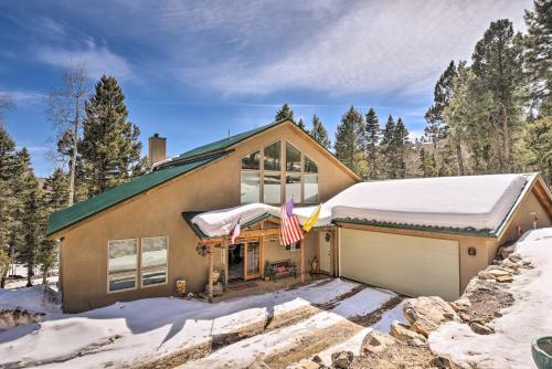a house with a flag in front of it at Expansive Angel Fire Retreat 1 Mi to Fishing! in Angel Fire