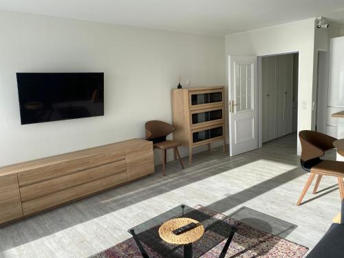 a living room with a flat screen tv on a wall at Alte Teestube in Norderney