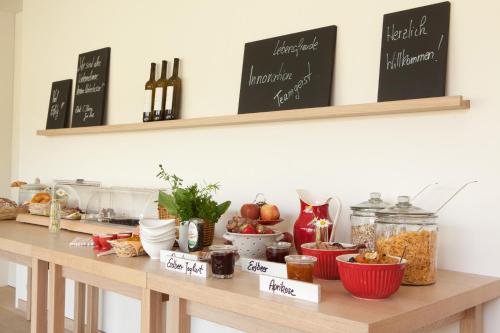 a kitchen counter with a table with food on it at WeinKulturgut Longen-Schlöder in Longuich