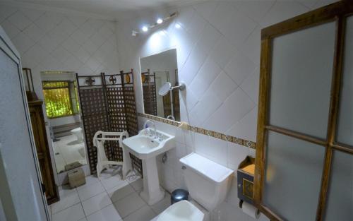 y baño con lavabo, aseo y espejo. en Villaguay B&B, en Casas de Chacabuco