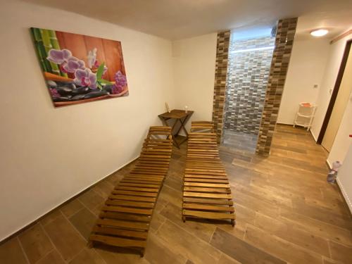 a hallway with wooden stairs in a room with a painting at Apartmány Kubova Huť in Kubova Huť