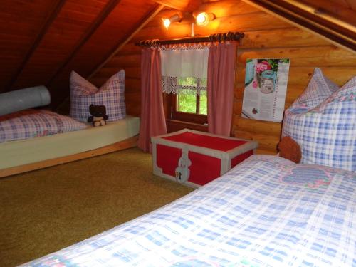 a bedroom with a bed and a window in a cabin at Ferienhaus Sachse in Pockau