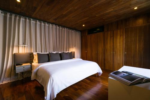 a bedroom with two beds and wooden walls and wood floors at Dos Casas Hotel & Spa in San Miguel de Allende