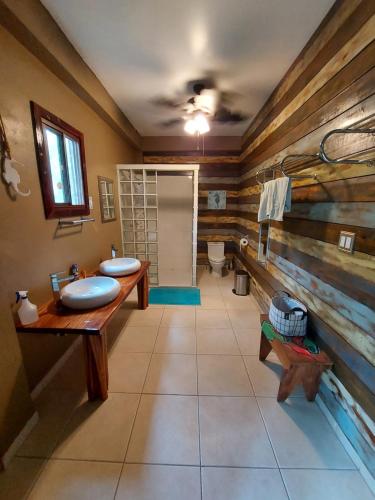 a bathroom with two sinks and a toilet at Casa Oceana Bed & Breakfast in Bocas del Toro