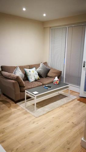 a living room with a couch and a coffee table at Lowghyll suite in Bowness-on-Windermere