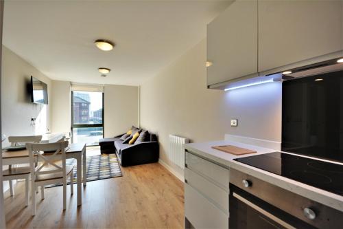 a kitchen and living room with a couch and a table at Quayside Central in Liverpool