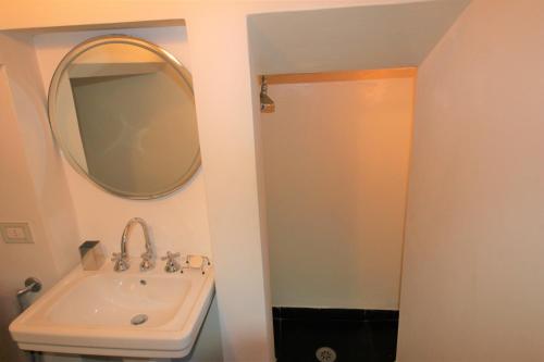 a bathroom with a sink and a mirror at Villa Franca Portofino by KlabHouse in Portofino