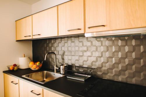 a kitchen with a sink and a counter top at Apartamenty 'Okno z widokiem' in Wisła