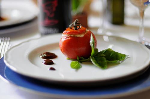 a tomato on a plate on a table at Torre Don Virgilio Country Hotel in Cannizzara