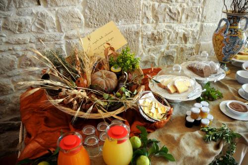 a table topped with a basket of food and bread at Torre Don Virgilio Country Hotel in Cannizzara