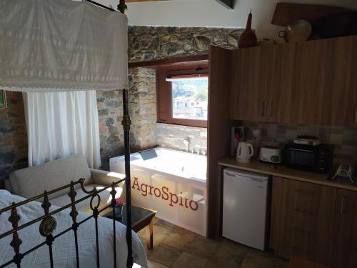 a kitchen with a bath tub in a room at AgroSpito Traditional Guest House in Agros