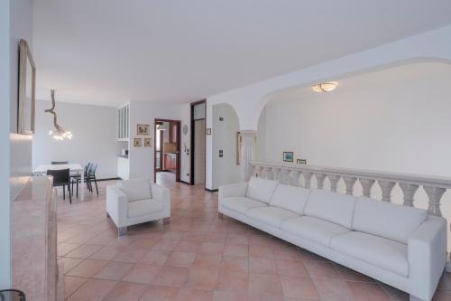een woonkamer met een bank en een tafel bij Casa Mary Tre - attico con terrazza a 2 passi dal lago in Sirmione
