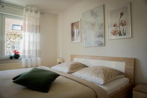 a bedroom with a bed with two pillows and a window at Ferienwohnung Donau in Balingen
