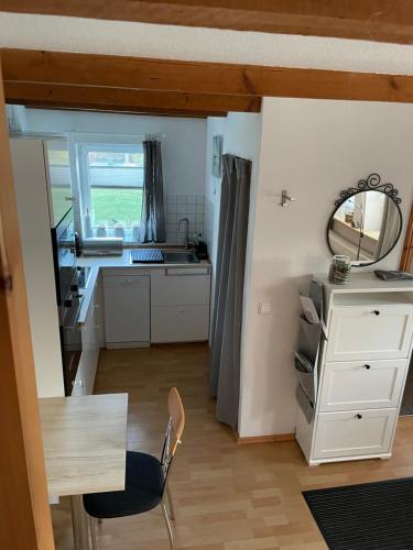 a small kitchen with a table and a mirror at Gästehaus Kantelberg in Dahme