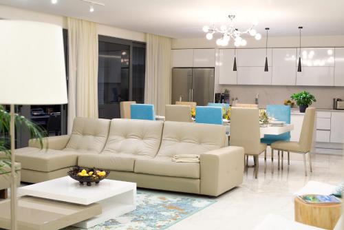 a living room with a couch and a dining room at Luxury Villa Aleana in Portimão