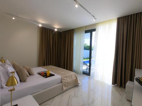 a bedroom with a bed and a large window at Luxury Villa Aleana in Portimão