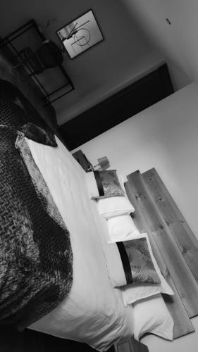 a black and white photo of a bed with pillows at La Lagareta de Olivia in Trevejo