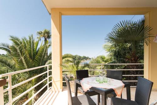 a patio with a table and chairs on a balcony at Villa Anna in Savudrija