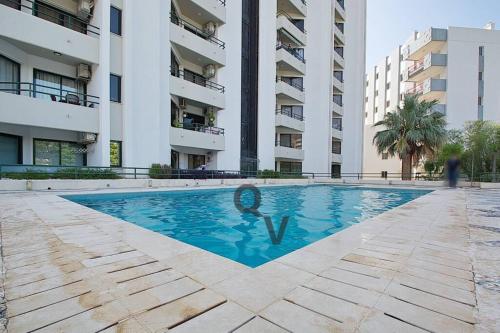 a swimming pool in the middle of a building at Vilamoura Marina Extraordinary 70 m2 T1, Marina 200m , beach 300m in Vilamoura