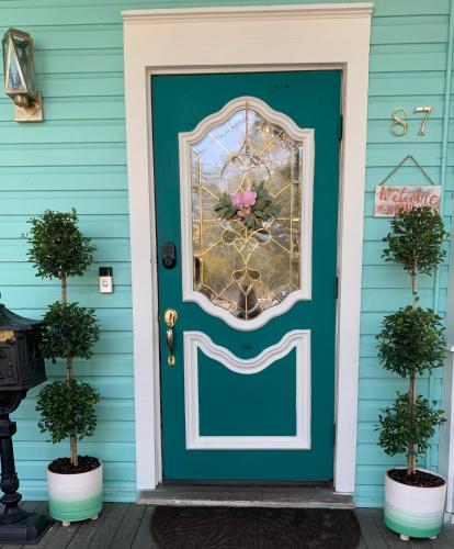 a blue front door with a mosaic window and a flower at Peace & Plenty Inn Bed and Breakfast Downtown St Augustine-Adults Only in Saint Augustine