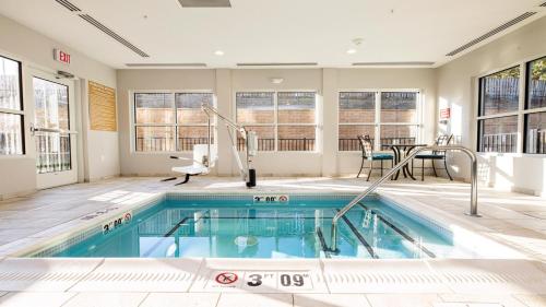a swimming pool in a large room with a house at Candlewood Suites - Dumfries - Quantico by IHG in Dumfries