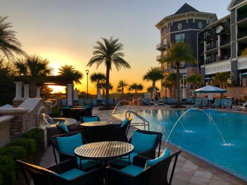a patio with a pool, chairs, and tables at Henderson Beach Resort in Destin
