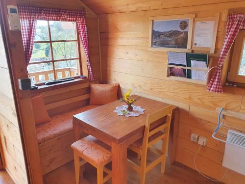 a dining room with a table in a cabin at Gnezdo Vid-ik in Čatež ob Savi