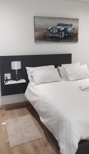 a bedroom with a bed with a car on the wall at Casa Mo Boutique Guest House in Bloemfontein