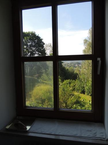 a window with a view of a field through it at FW Zauberblick in Zwiesel
