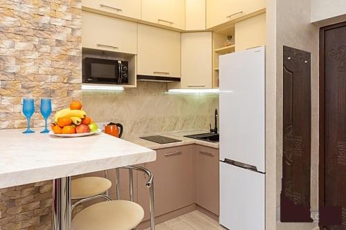 a kitchen with a table with a bowl of fruit on it at Видовая квартира в Аркадии с балконом in Odesa