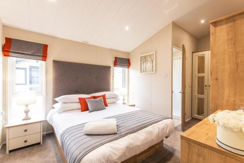 a bedroom with a large bed in a room at Heathery Lodge with Hot Tub in York
