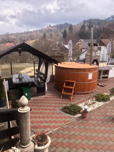 a hot tub on a patio with a black canopy at Casa Daniel in Bran