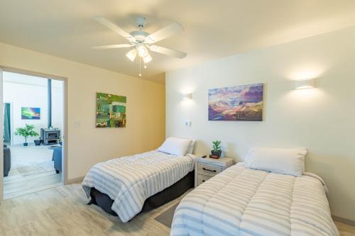 a bedroom with two beds and a ceiling fan at The Molina Center in Mesa