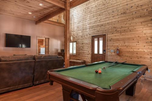a living room with a pool table and a couch at Wait for it Getaway in Angel Fire