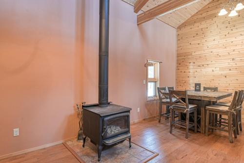a wood stove in a room with a dining table at Wait for it Getaway in Angel Fire
