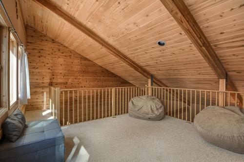 a attic room with a couch and two chairs at Wait for it Getaway in Angel Fire