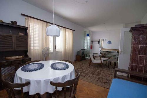 a dining room with a table and chairs in a room at Apartment in Veli Losinj 34684 in Veli Lošinj