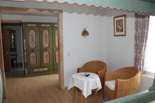 a room with two chairs and a table and a door at Hotel Zur Erholung in Braunlage