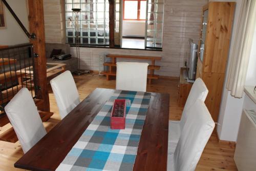 a wooden table with white chairs around it in a room at Hotel Zur Erholung in Braunlage