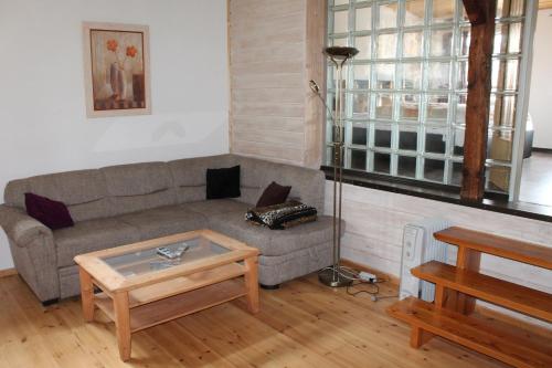 a living room with a couch and a coffee table at Hotel Zur Erholung in Braunlage