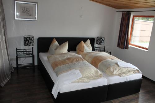 a bed with pillows on it in a bedroom at Hotel Zur Erholung in Braunlage
