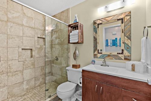 a bathroom with a shower and a toilet and a sink at Seas the Day in Navarre