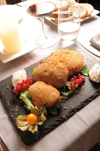 a black plate of food on a table at Hotel Astra in Livigno