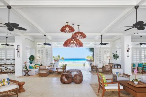 an open living room with a view of the beach at Half Moon in Montego Bay