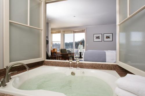 a bathroom with a bath tub with a view of a bedroom at Resort at Port Ludlow in Port Ludlow