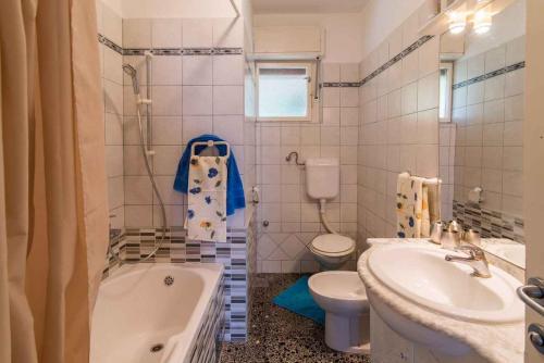 a bathroom with a tub and a toilet and a sink at Apartment in Vrbnik/Insel Krk 13616 in Vrbnik