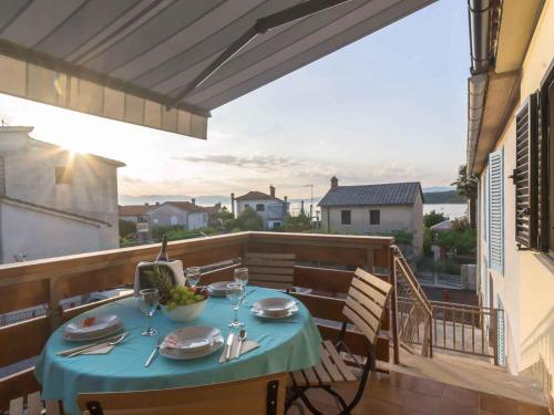a table on a balcony with a blue table cloth at Apartment in Njivice/Insel Krk 27855 in Njivice