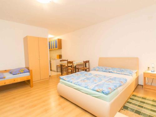 a bedroom with a bed and a dining room at Studio in Njivice/Insel Krk 27373 in Njivice