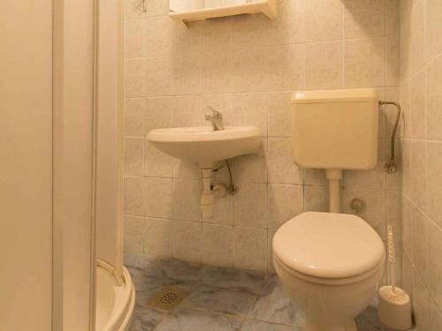 a bathroom with a toilet and a sink at Studio in Njivice/Insel Krk 27373 in Njivice